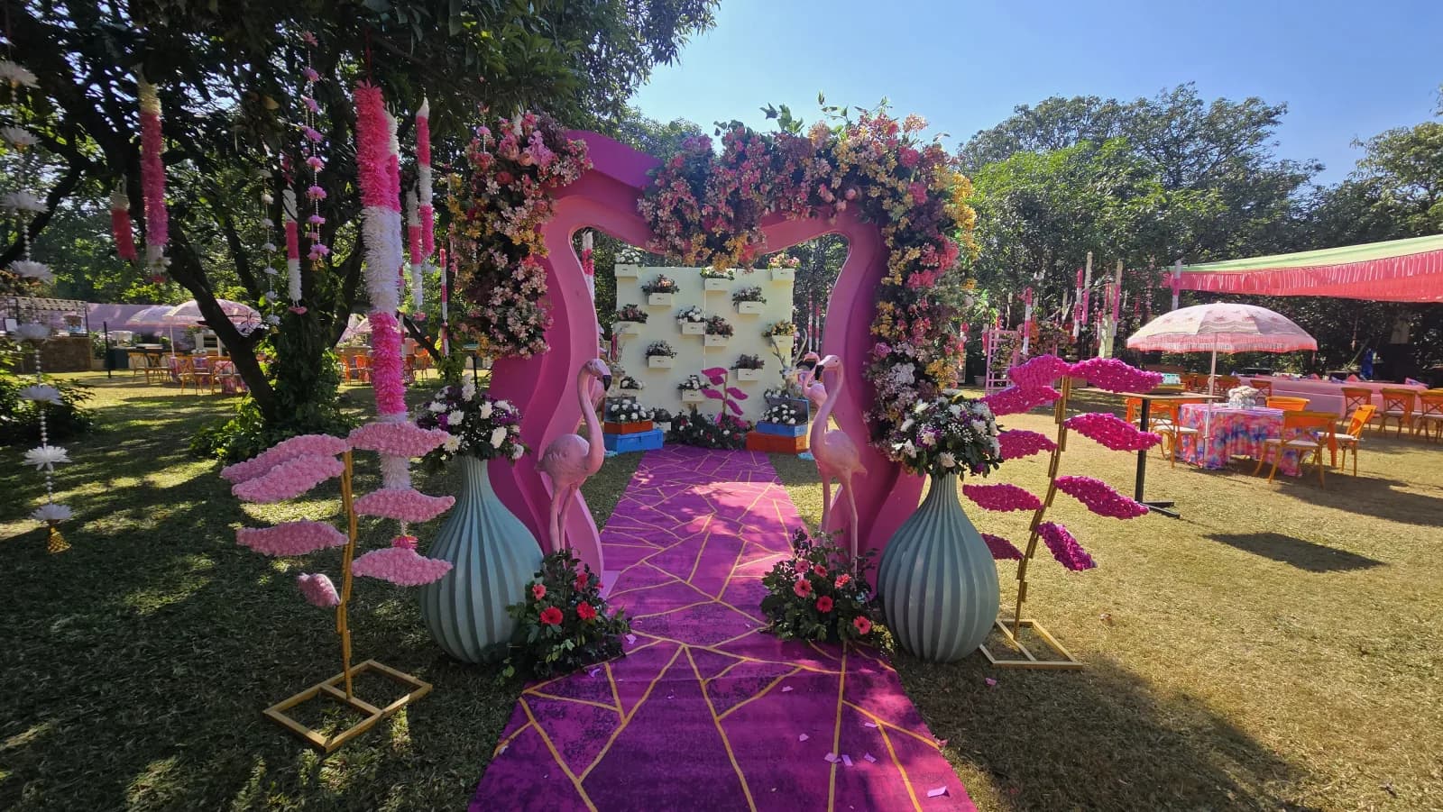 A flamingo-and-floral welcome entrance on the lawn